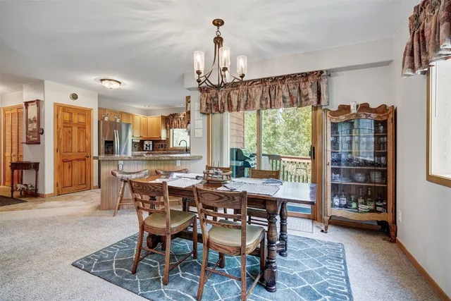 a balcony with chairs and a potted plant