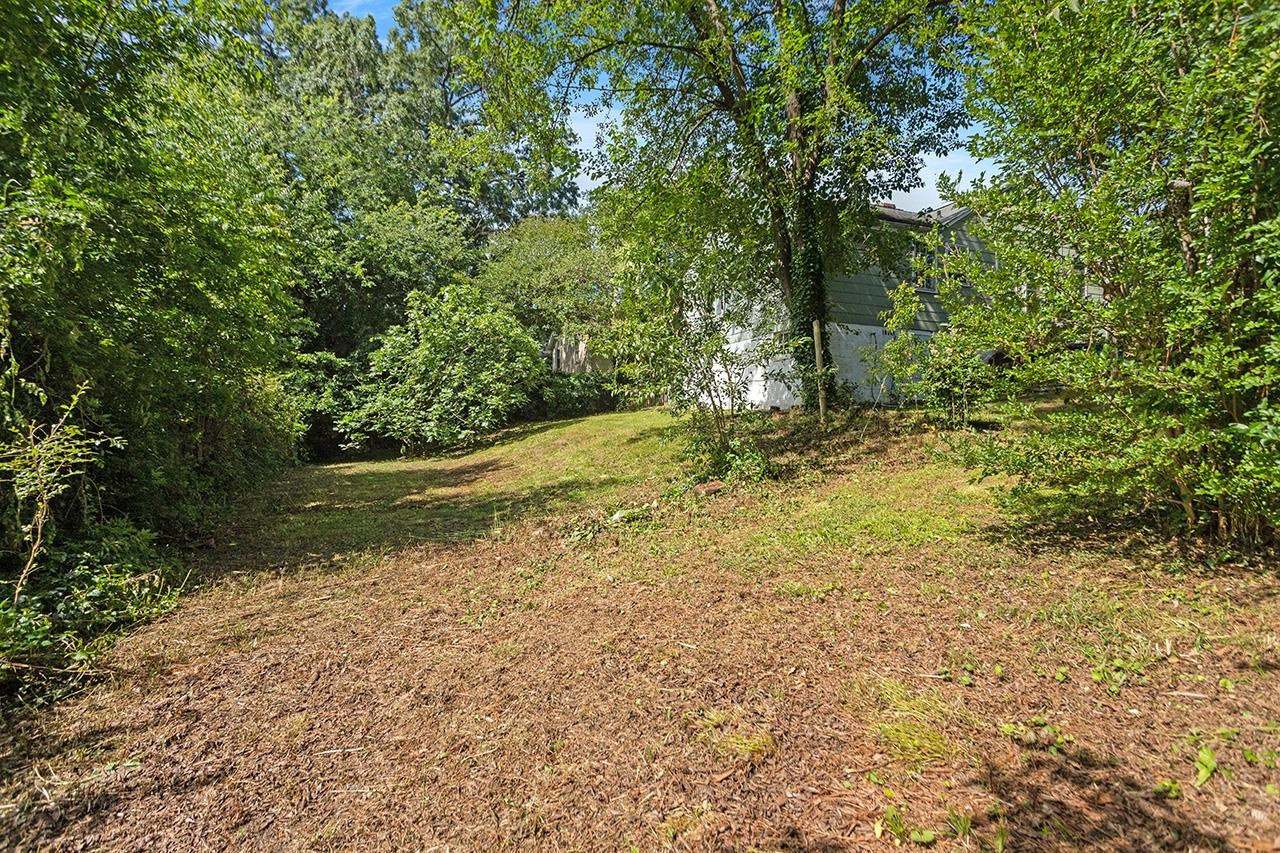 1208 Clifton Street Raleigh, NC 27604 - Photo 6 of 33 The back of the lot is much wider than the front, lending many options for utilizing different yard spaces