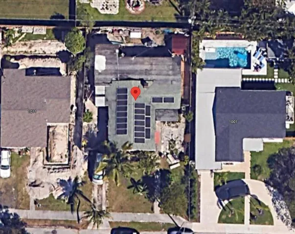 an aerial view of a building with street