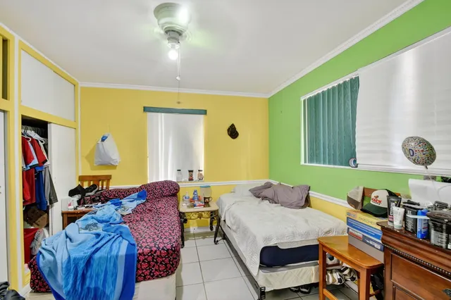 a bedroom with furniture and a chair