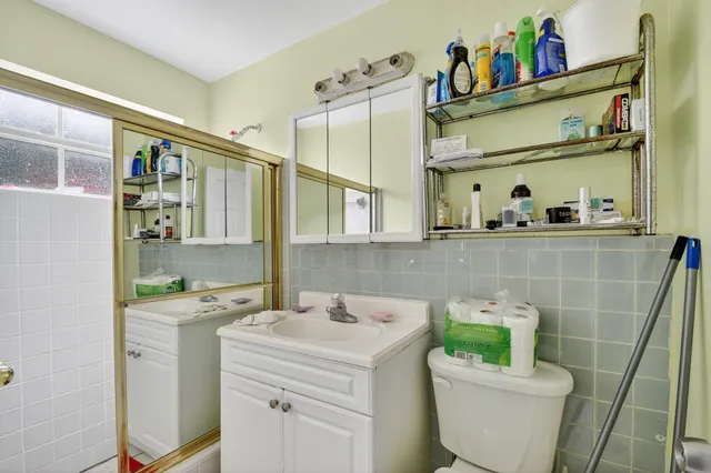a bathroom with a sink mirror vanity and toilet