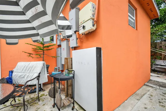 a backyard of a house with table and chairs