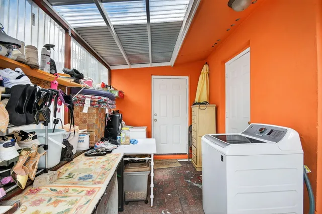a view of a chair and table in the backyard