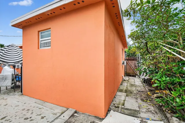 a view of a hallway and a dining area with plants