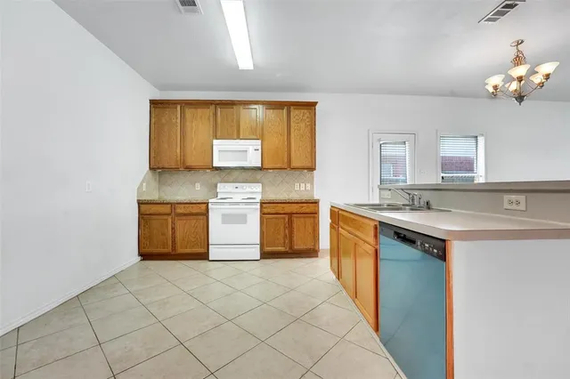 a kitchen with stainless steel appliances granite countertop a sink and cabinets