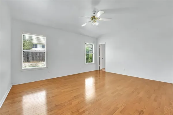 a view of a livingroom with a fireplace a chandelier and wooden floor