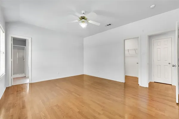 a view of empty room with wooden floor
