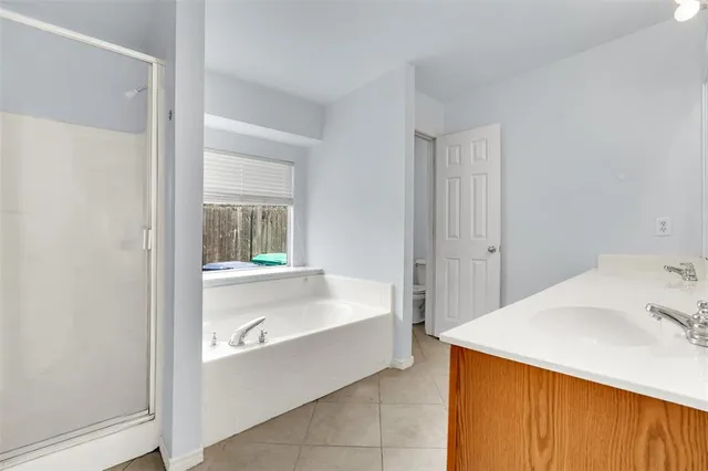 a bathroom with a bathtub and shower