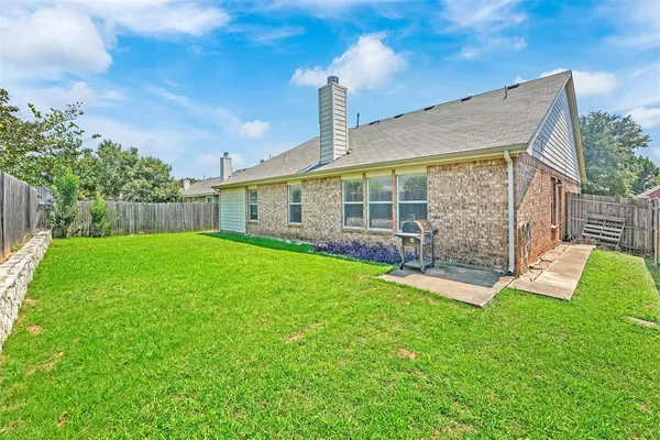 a view of house with backyard