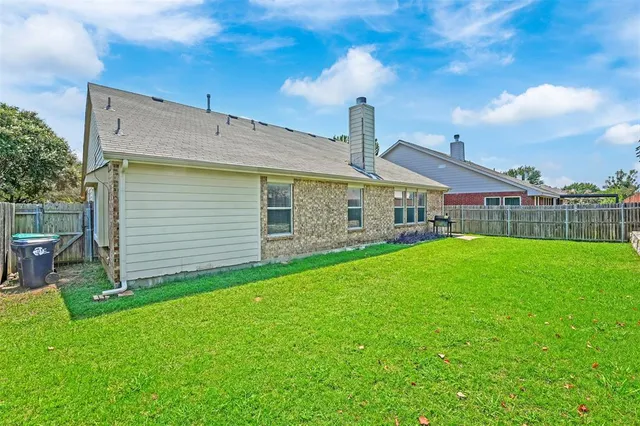 a view of a house with a yard and sitting area