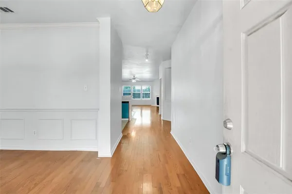 a view of a hallway with wooden floor