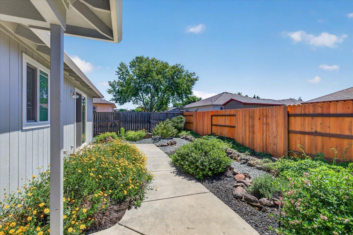 2618 Rabun Way Central Point, OR 97502 - Photo 36 of 42 a view of backyard with potted plants and wooden fence
