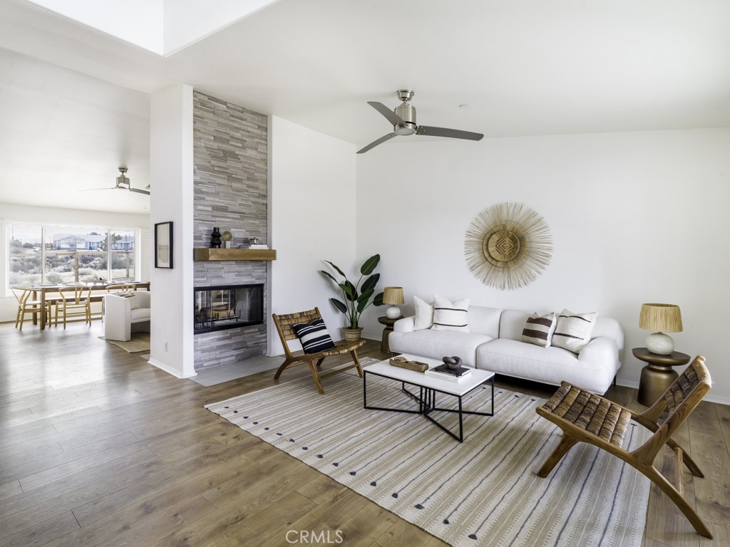 61745 Pueblo Trail Joshua Tree, CA 92252 - Photo 1 of 1 a living room with furniture and wooden floor