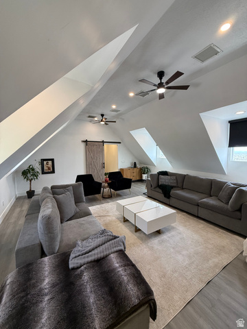 965 North 800 East Springville, UT 84663 - Photo 24 of 46 Living room with wood finished floors, a ceiling fan, a barn door, lofted ceiling, and recessed lighting