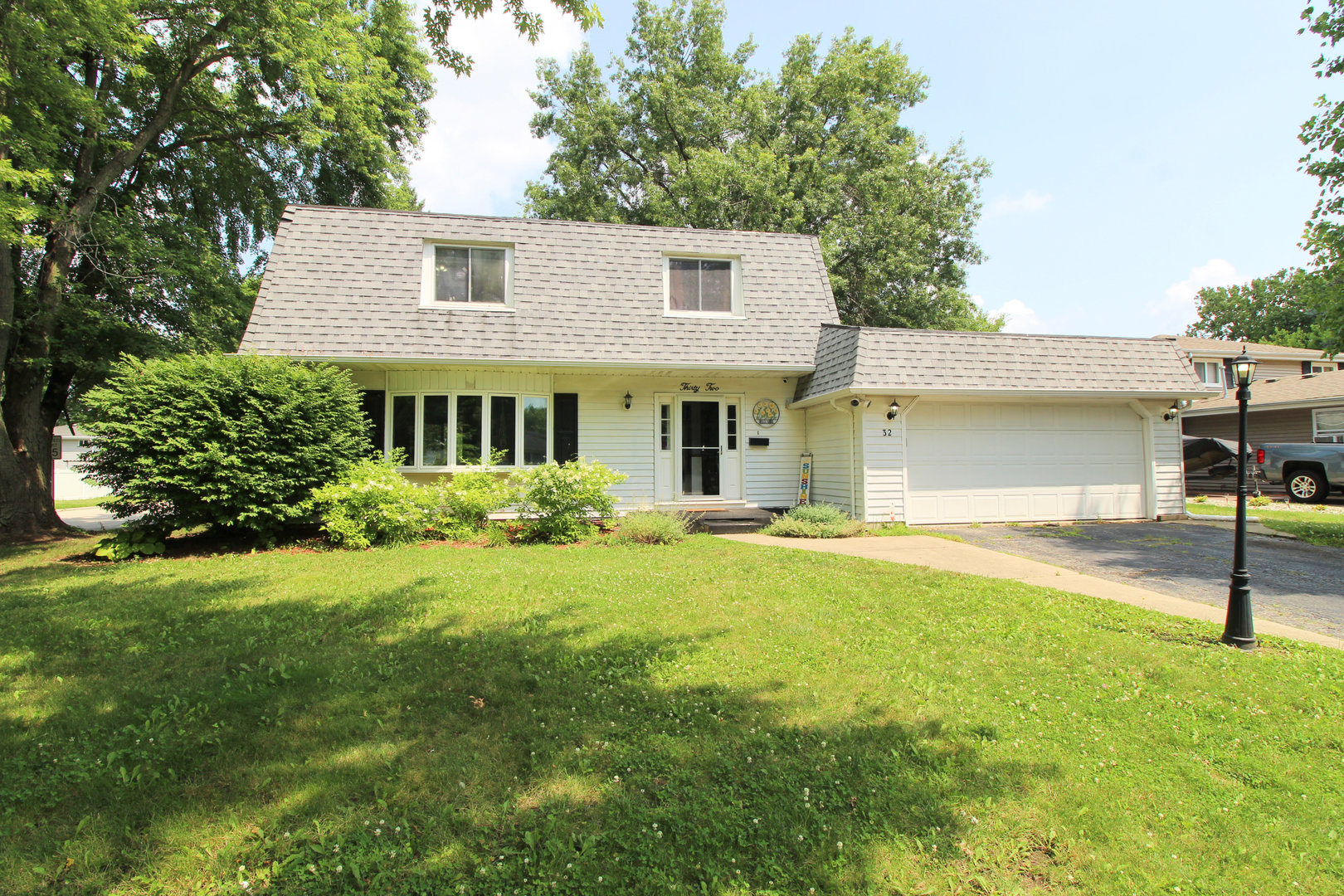32 Emery Drive Bourbonnais, IL 60914 - Photo 2 of 17 a front view of a house with a yard and garage