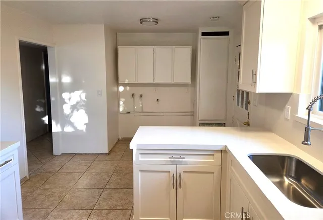 a kitchen with a sink cabinets and utility