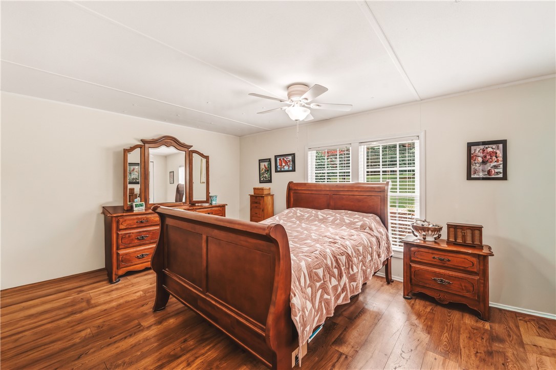 942 Chambers Hill Road Seneca, SC 29672 - Photo 15 of 38 Comfortable bedroom with durable hardwood flooring and refreshing ceiling fan.