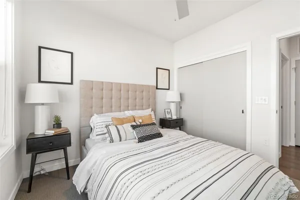 a bedroom with a bed and a lamp on table