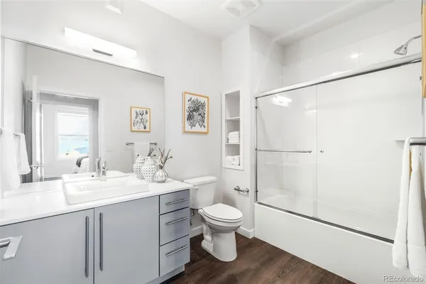 a bathroom with a toilet a sink and a mirror