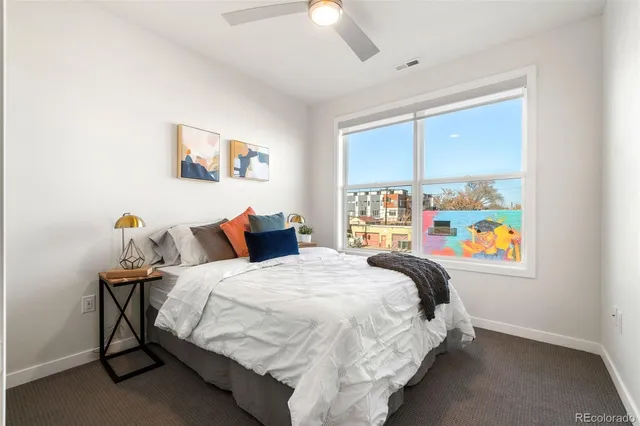 a bed sitting in a bedroom next to a window