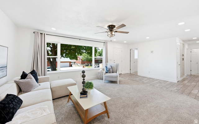 120 North 1230 E Street Springville, UT 84663 - Photo 9 of 60 Bright interior space featuring a large window, recessed lighting, ceiling fan, carpet flooring, and an entry door