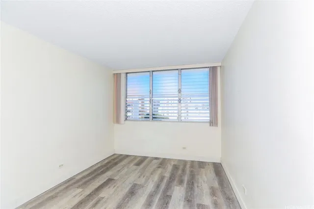 wooden floor in an empty room and a window