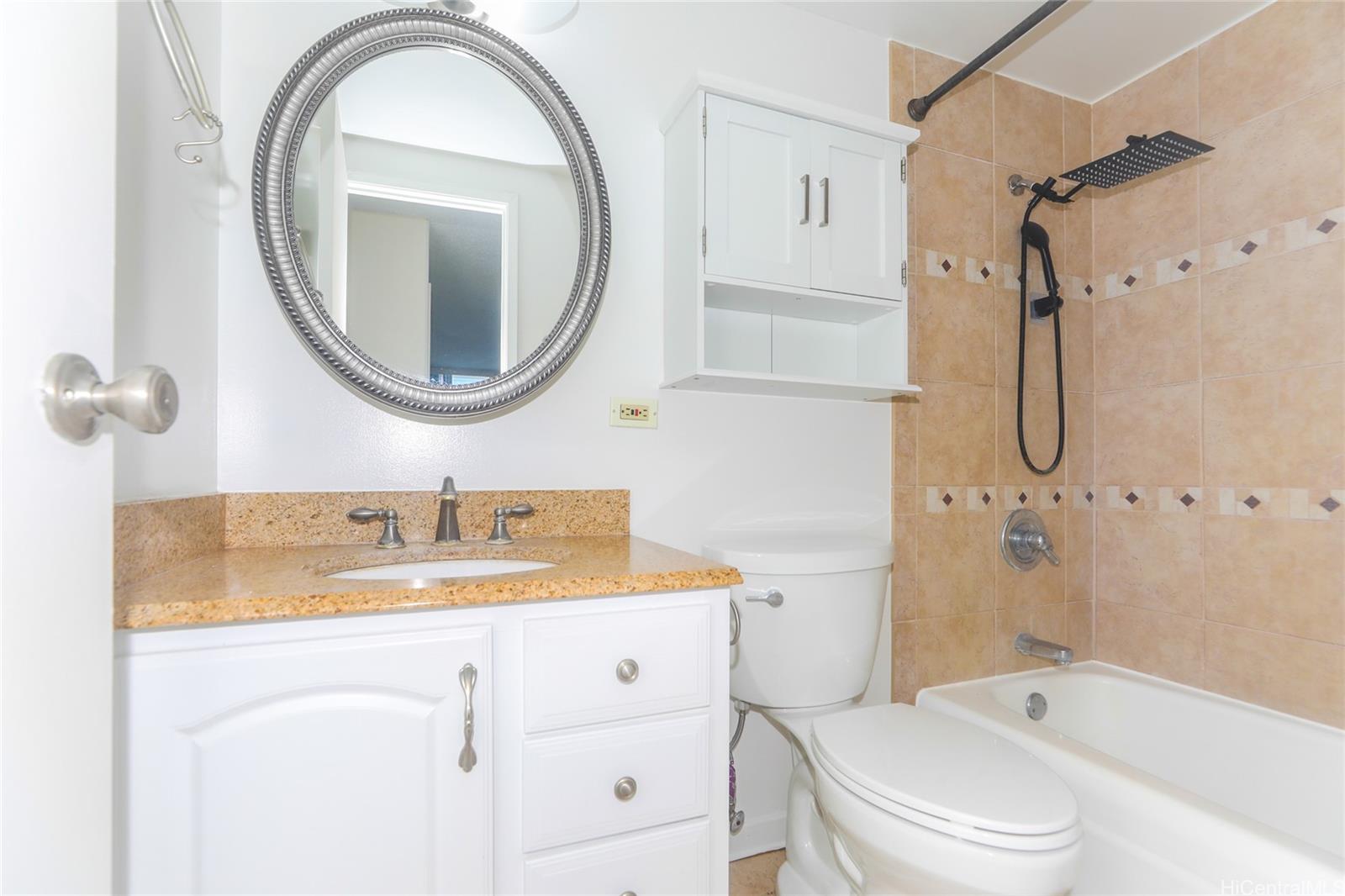 2977 Ala Ilima Street, Unit 610 Honolulu, HI 96818 - Photo 16 of 25 a bathroom with a granite countertop sink toilet and shower