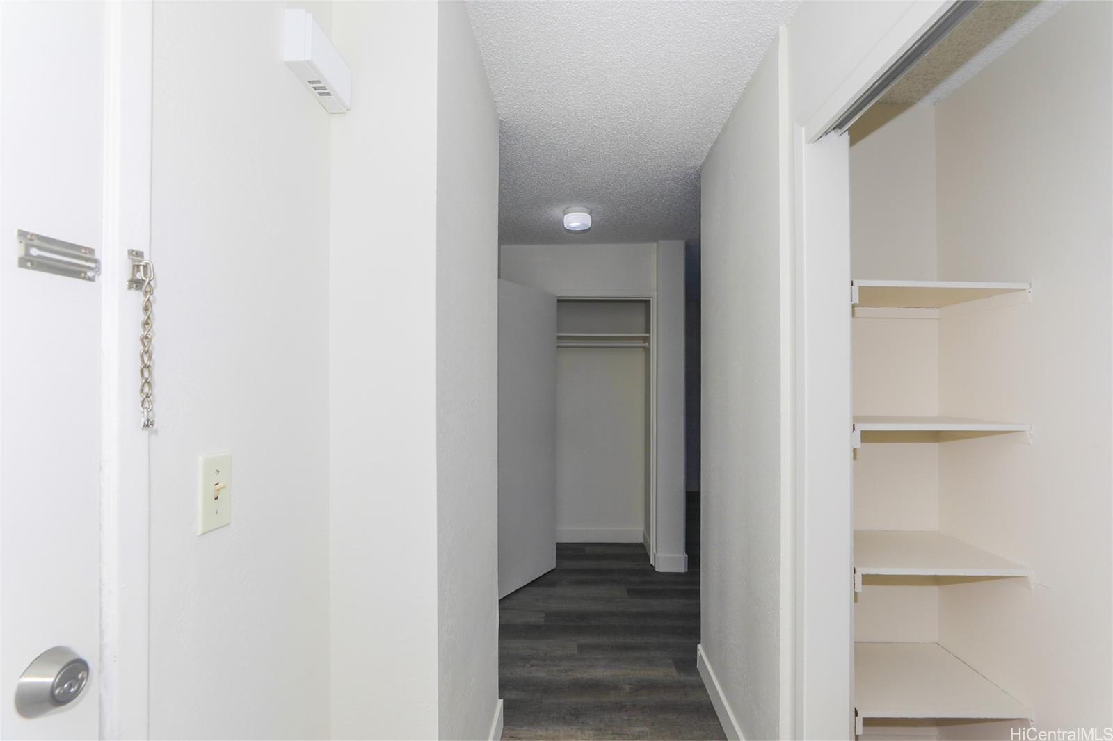 2977 Ala Ilima Street, Unit 610 Honolulu, HI 96818 - Photo 19 of 25 a view of a hallway with wooden floor