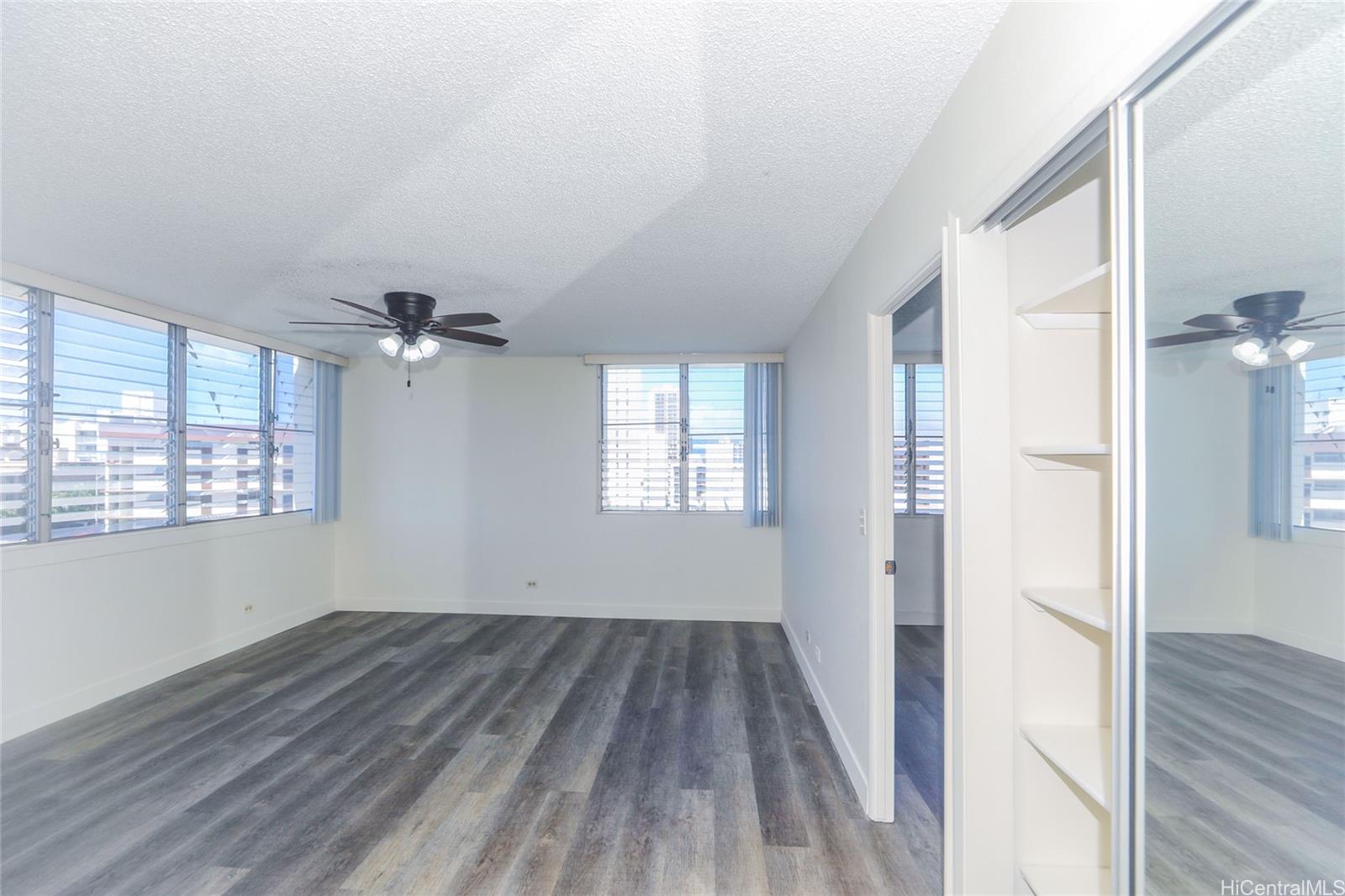 2977 Ala Ilima Street, Unit 610 Honolulu, HI 96818 - Photo 2 of 25 a view of a room with wooden floors and window
