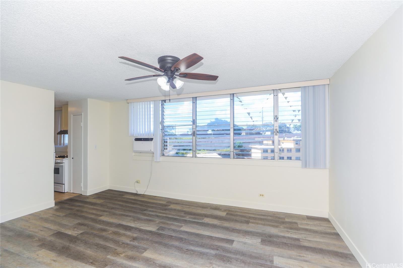 2977 Ala Ilima Street, Unit 610 Honolulu, HI 96818 - Photo 3 of 25 a view of empty room with wooden floor and fan