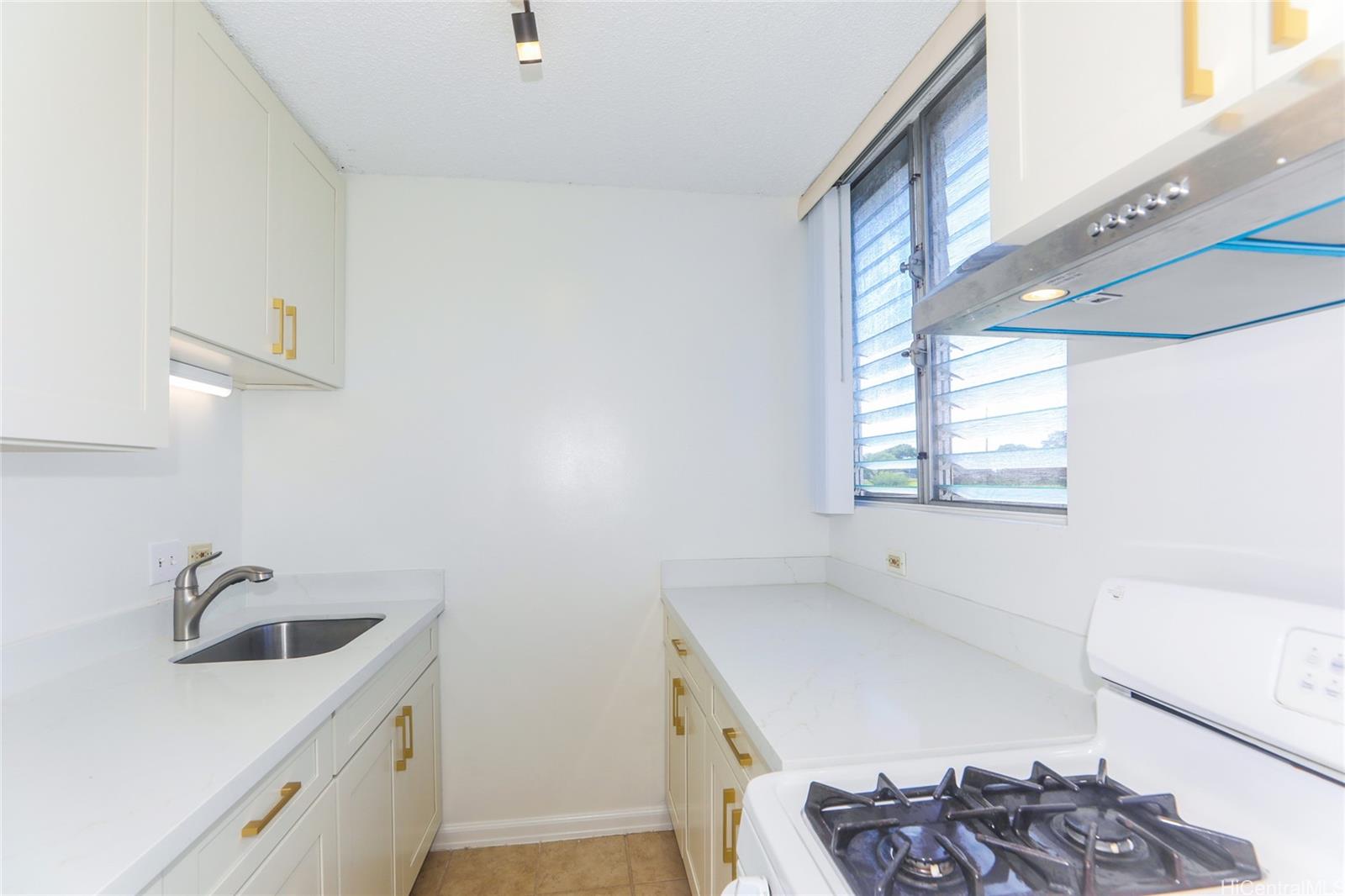 2977 Ala Ilima Street, Unit 610 Honolulu, HI 96818 - Photo 9 of 25 a kitchen with a sink stove and refrigerator