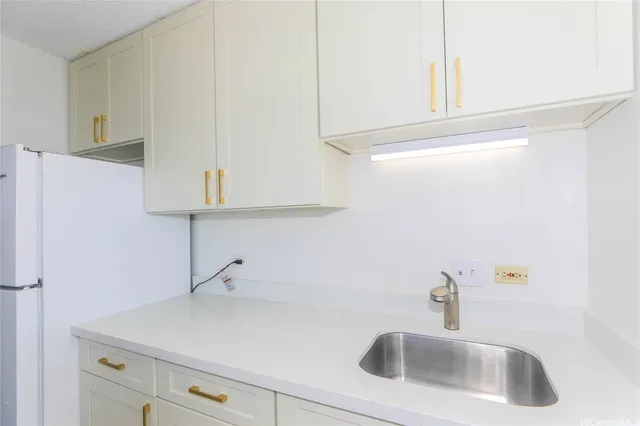 a kitchen with a sink and cabinets