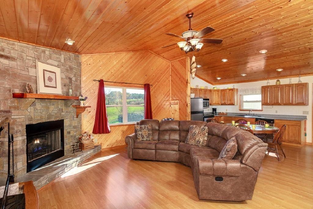 1736 Mountain Ridge Road Newport, TN 37821 - Photo 4 of 18 a living room with furniture a fireplace and a chandelier