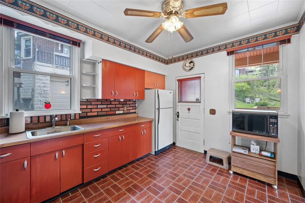 508 Cascade Road Pittsburgh, PA 15221 - Photo 19 of 46 a view of a hallway with a dining table and chairs