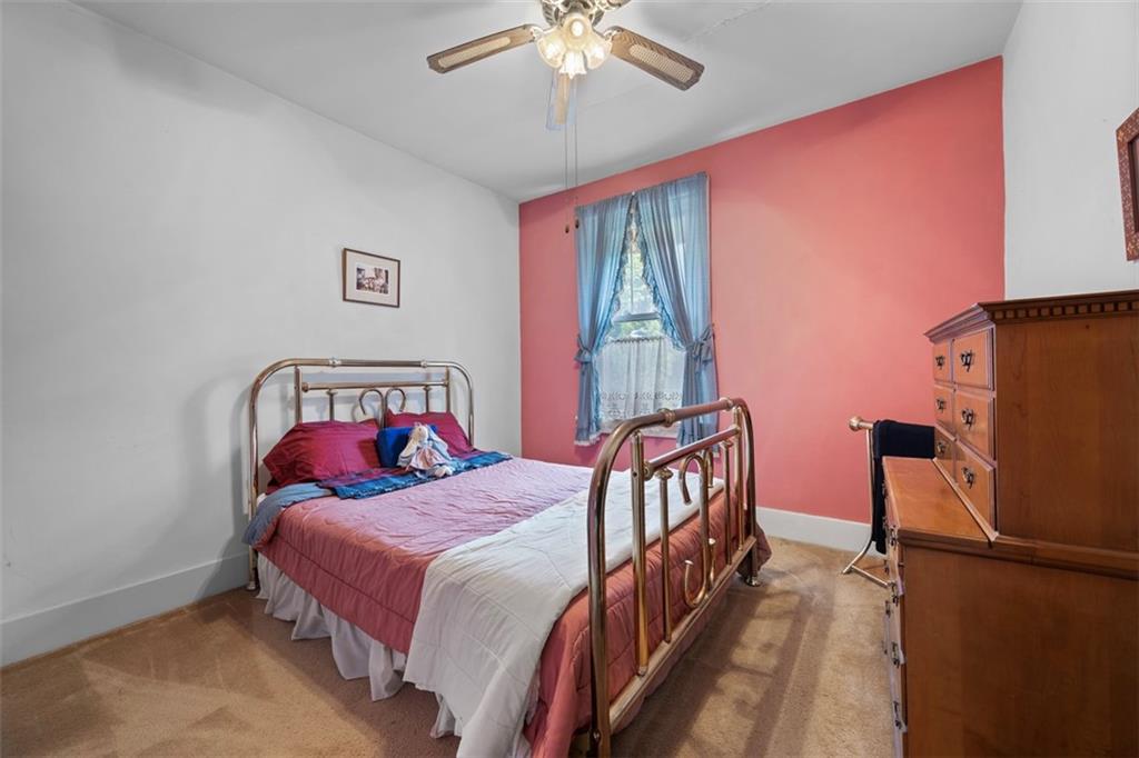 508 Cascade Road Pittsburgh, PA 15221 - Photo 26 of 46 a bedroom with a bed and a chandelier