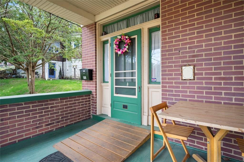 508 Cascade Road Pittsburgh, PA 15221 - Photo 36 of 46 a view of a patio with a table and chairs and a large tree