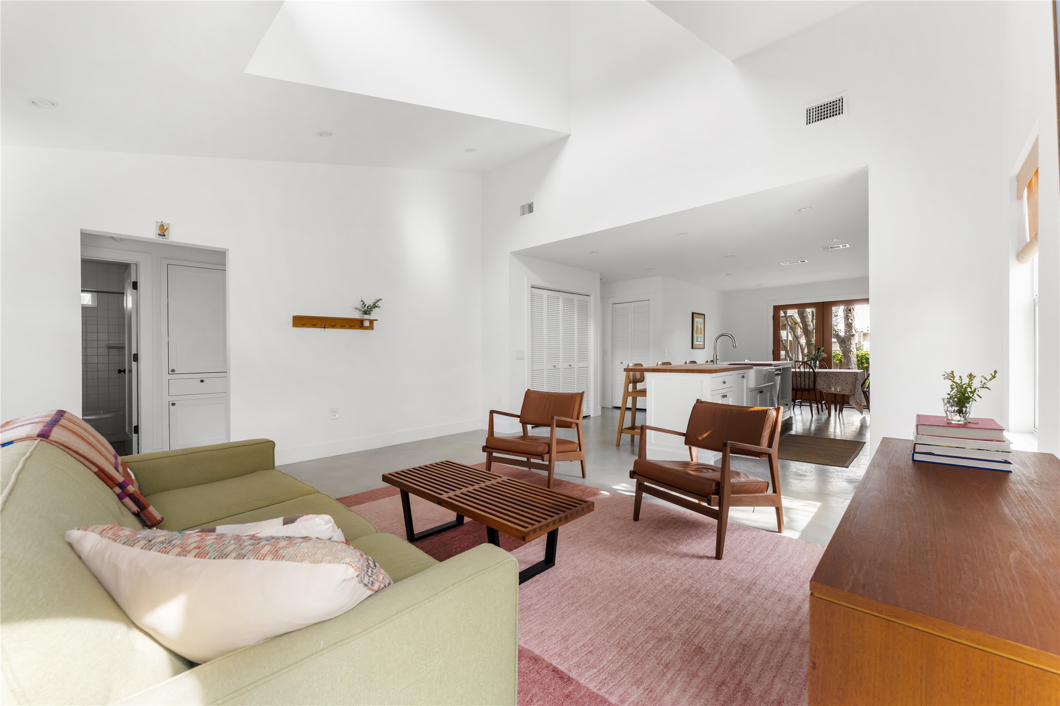 400 Delmar Avenue Austin, TX 78752 - Photo 12 of 36 The concrete floors continue through the living area, offering durability and a consistent look that pairs well with the crisp walls