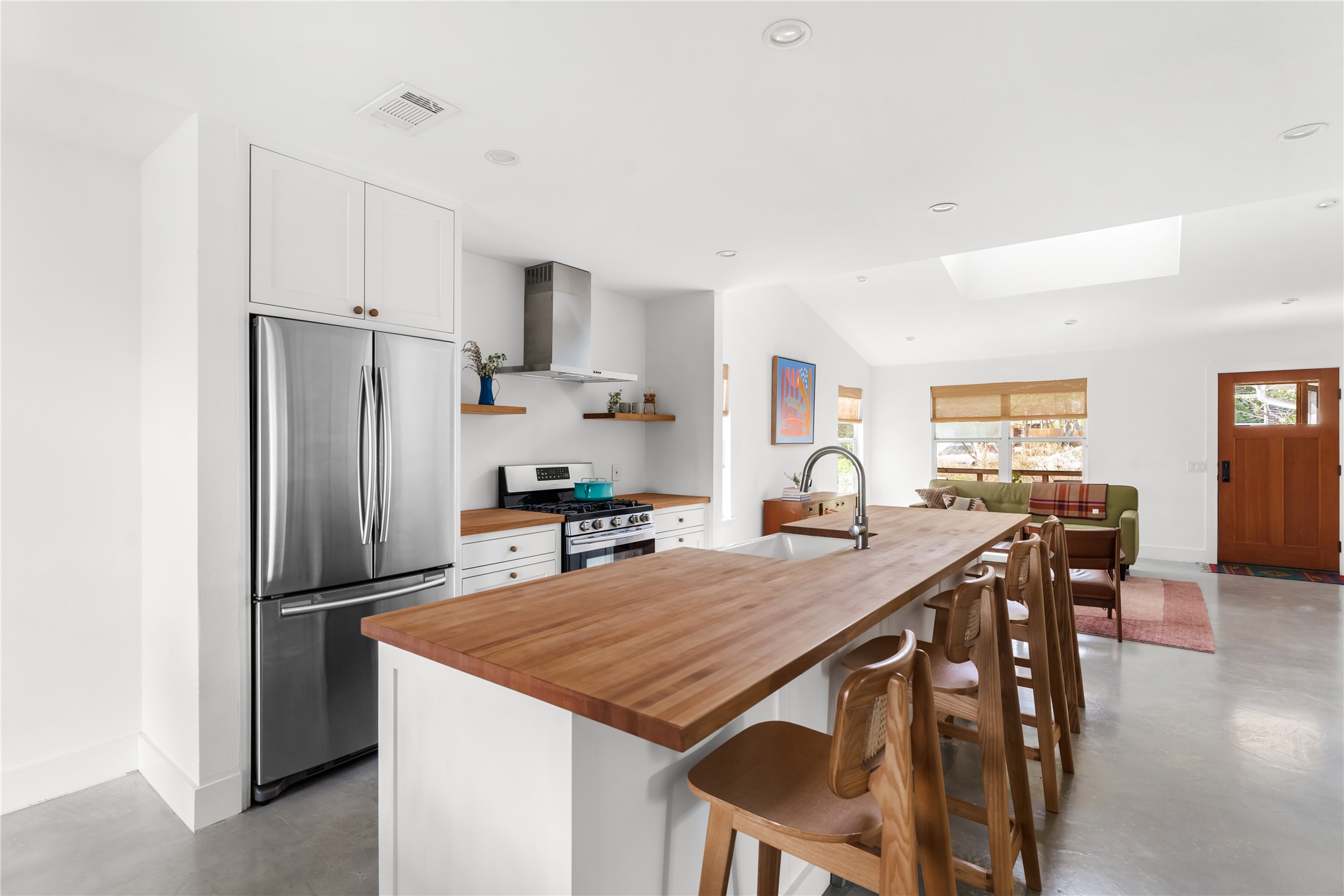 400 Delmar Avenue Austin, TX 78752 - Photo 16 of 36 The center island anchors the kitchen with an apron front sink and extended breakfast bar, creating a natural place to prep, serve, or sit throughout the day