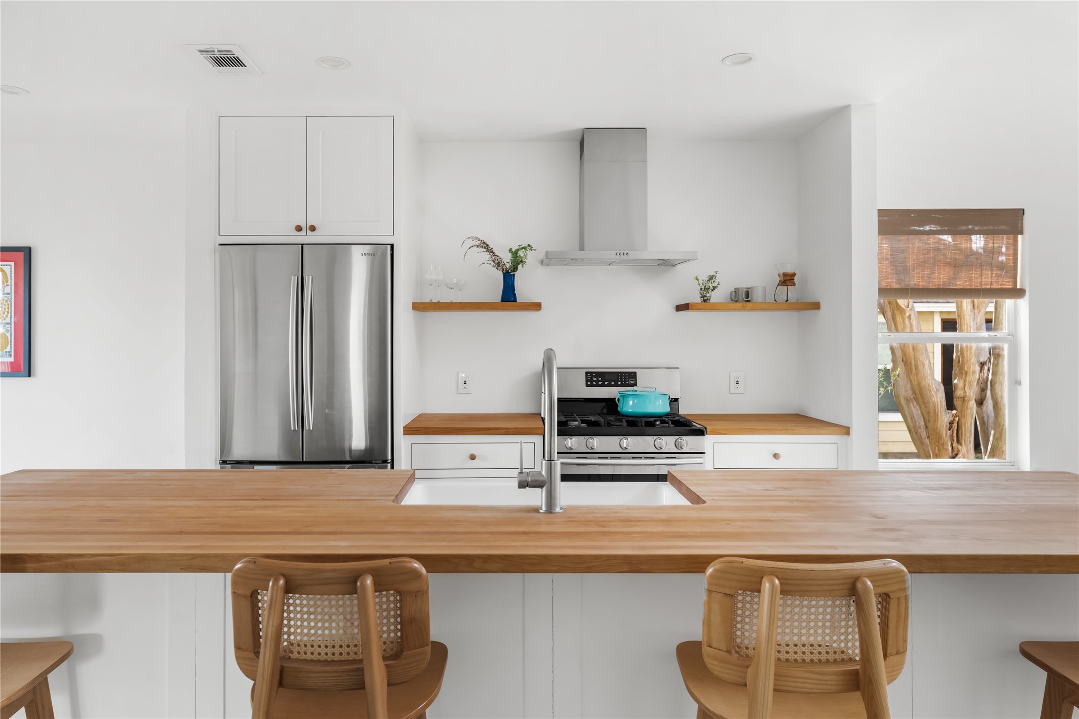400 Delmar Avenue Austin, TX 78752 - Photo 17 of 36 The breakfast bar side of the island offers space for casual seating, keeping the kitchen connected to conversation and activity in the living area