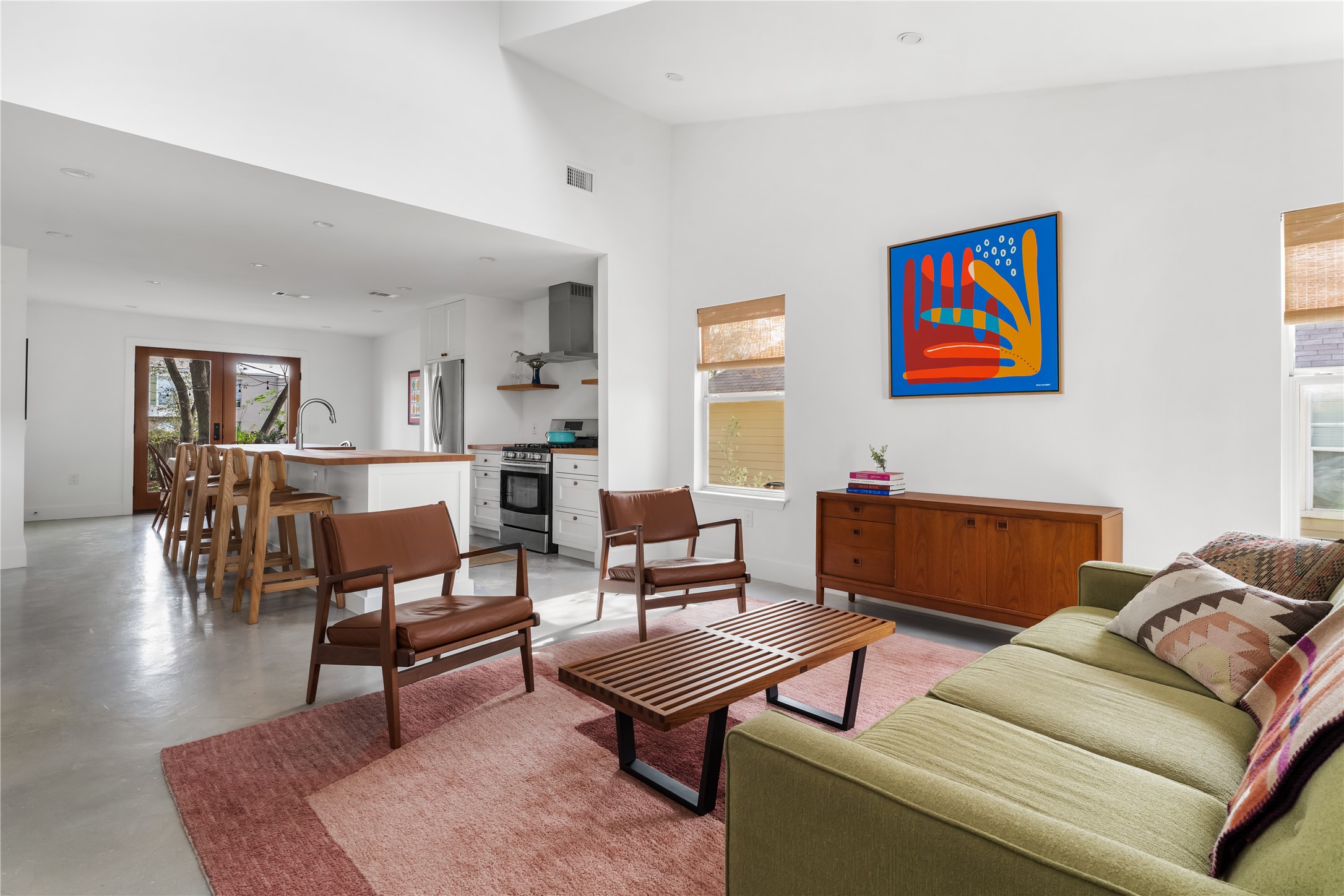 400 Delmar Avenue Austin, TX 78752 - Photo 2 of 36 The living room carries natural light throughout the day, with high ceilings and skim-coated concrete floors giving the space a clean, modern foundation