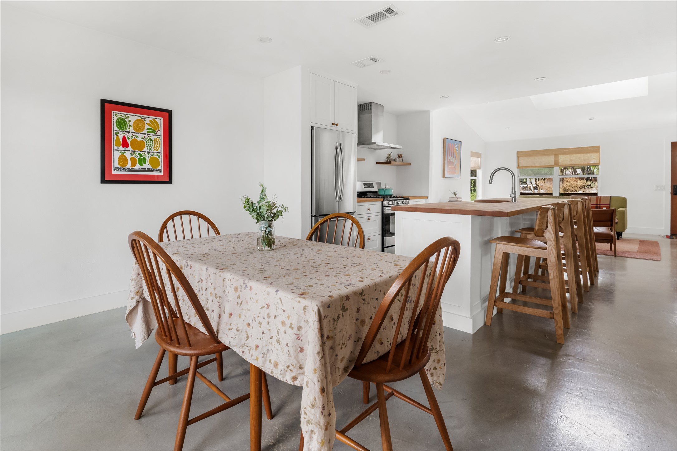 400 Delmar Avenue Austin, TX 78752 - Photo 23 of 36 Positioned between the kitchen and deck, the dining area works easily for everyday meals or longer evenings that move between indoor and outdoor seating