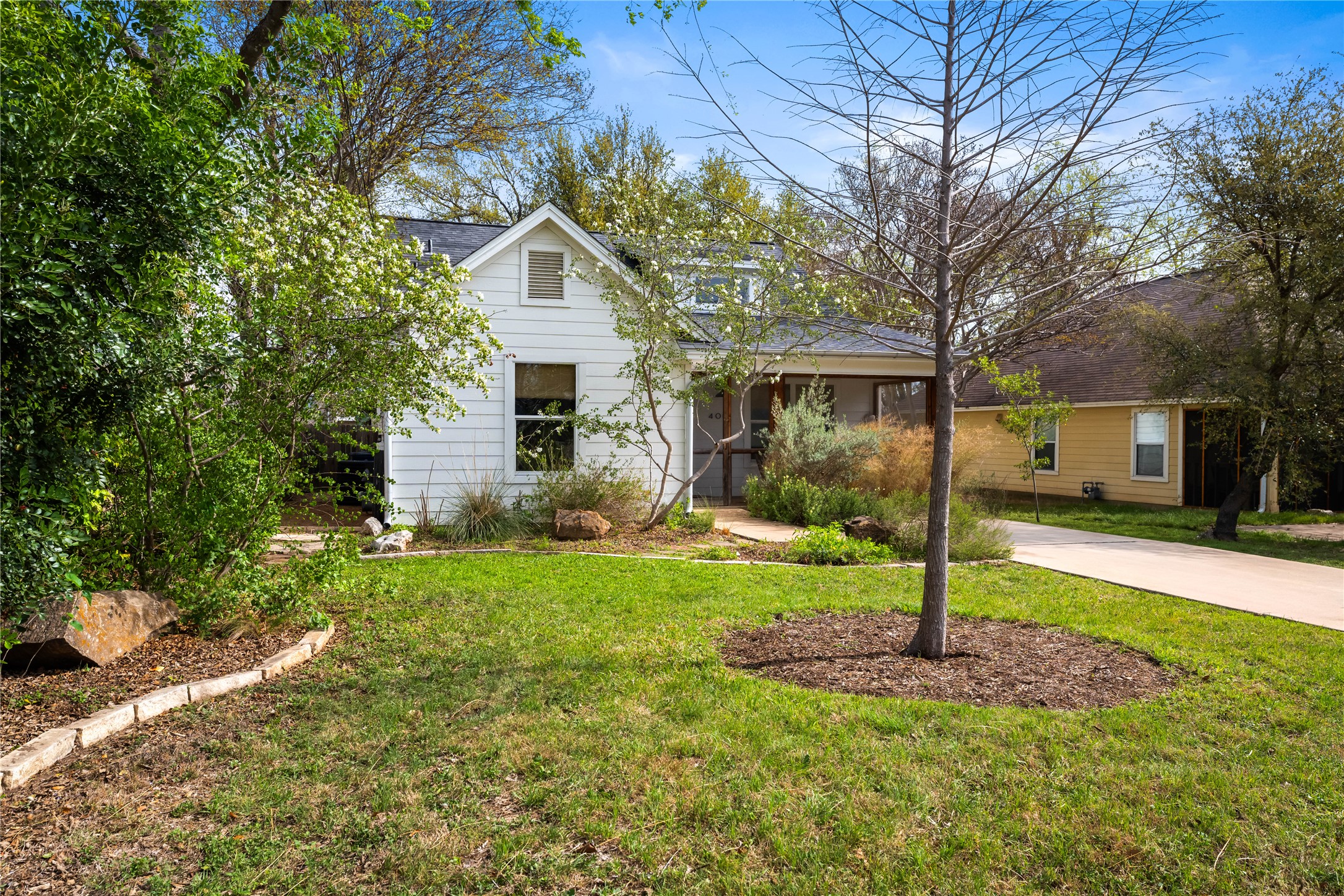 400 Delmar Avenue Austin, TX 78752 - Photo 7 of 36 Thoughtfully landscaped yard featuring drought-tolerant native plantings that blend beauty with resilience.