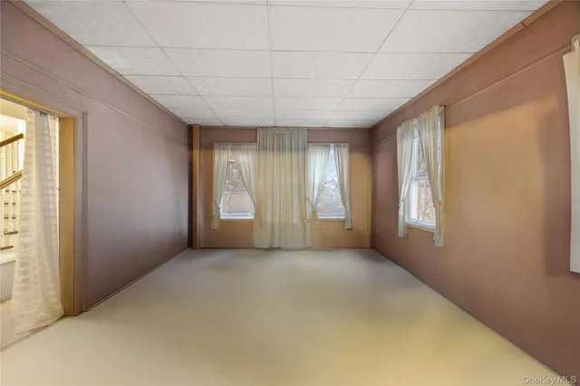 a view of an empty room with windows