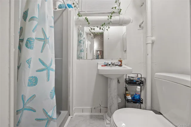 a bathroom with a sink mirror toilet and shower