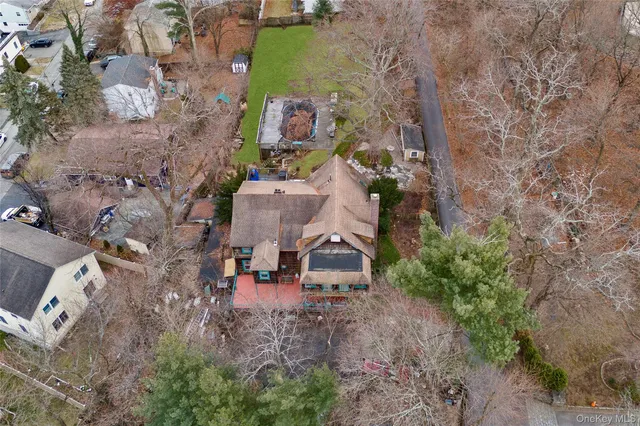an aerial view of a house with a yard and lake view