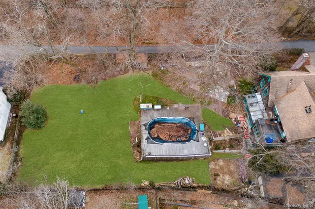 a aerial view of a house with a garden and lake view