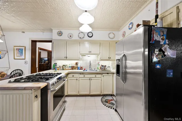 a kitchen with stainless steel appliances granite countertop a sink a stove and refrigerator