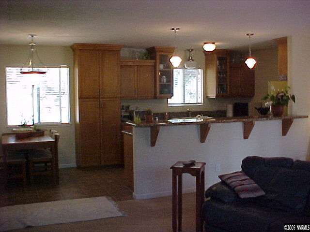 311 Chimney Rock Road Stateline, NV 89449 - Photo 4 of 8 a kitchen with granite countertop a sink cabinets and window