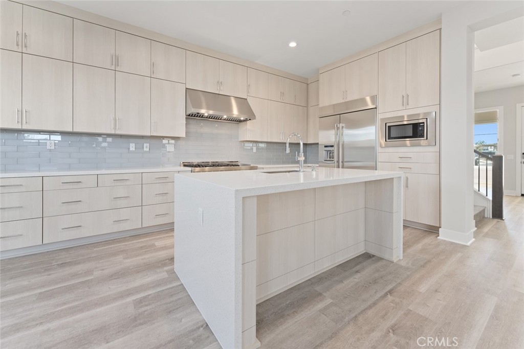 181 Hollyleaf Lake Forest, CA 92630 - Photo 13 of 36 a kitchen with white cabinets stainless steel appliances and sink