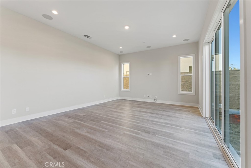 181 Hollyleaf Lake Forest, CA 92630 - Photo 14 of 36 an empty room with wooden floor and windows